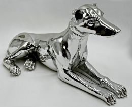 Silvered resin model of a recumbent greyhound, 52cm long