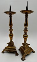 Good quality pair of antique bell metal pricket sticks with tri form bases, 37cm high (2)