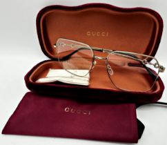 A pair of Gucci silver tone full-rim square metal eyeglasses featuring iconic Horsebit motif on