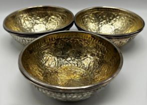 Good set of six Islamic silver bowls, embossed with naïve engrave decoration and gilt interiors, 5cm
