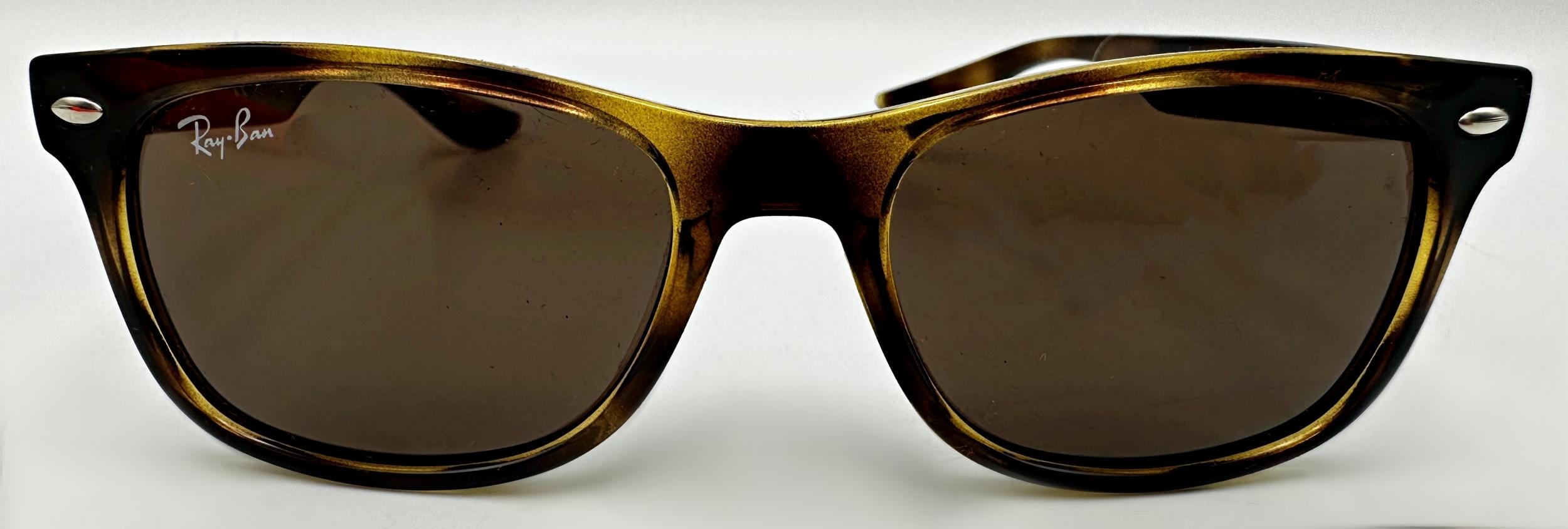 A pair of junior Ray-Ban tortoiseshell sunglasses for children in the iconic Wayfarer design,