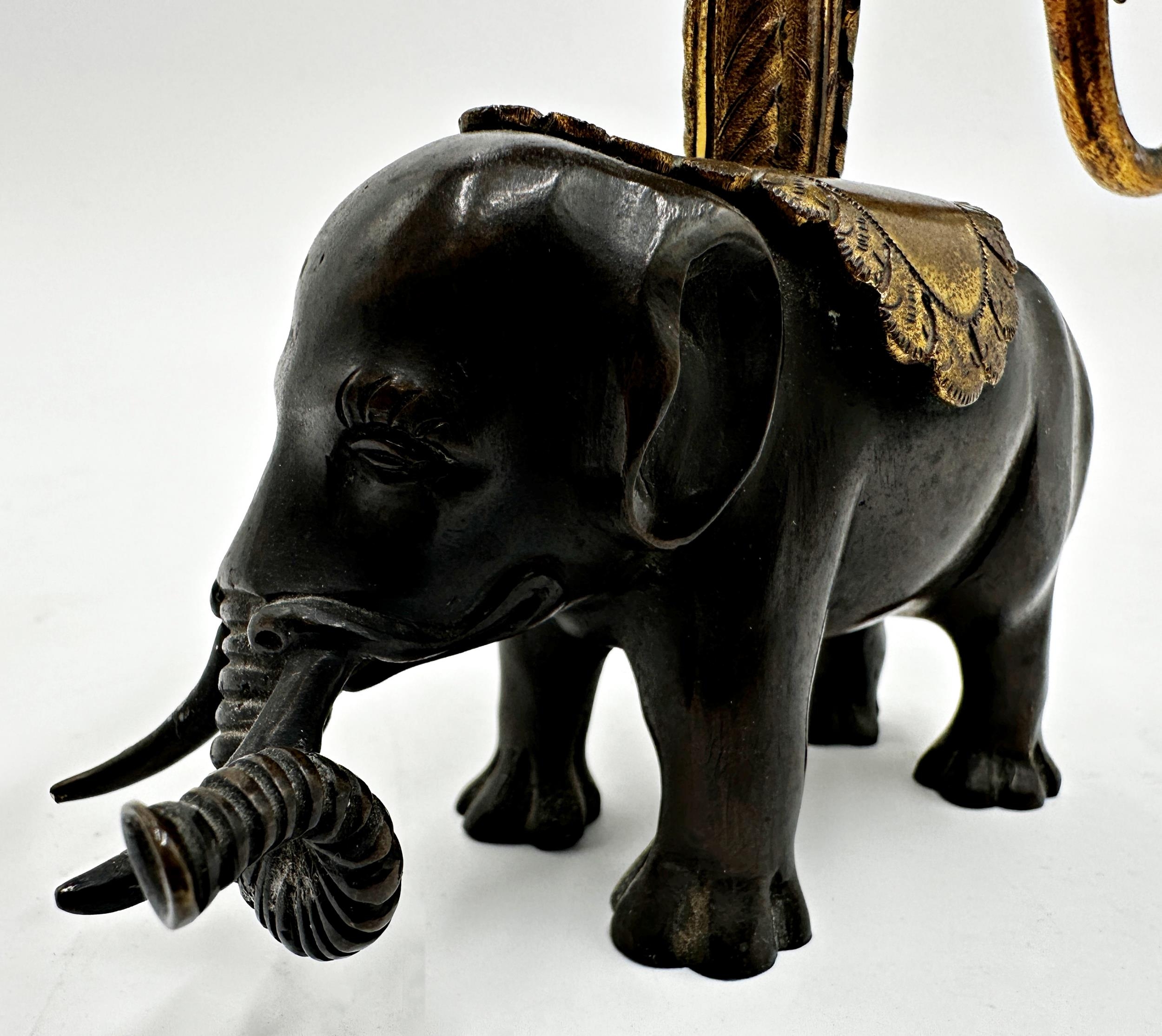 French bronze and ormolu twin branch candelabra, scrolled gilt branches on a cast standing elephant, - Bild 2 aus 2