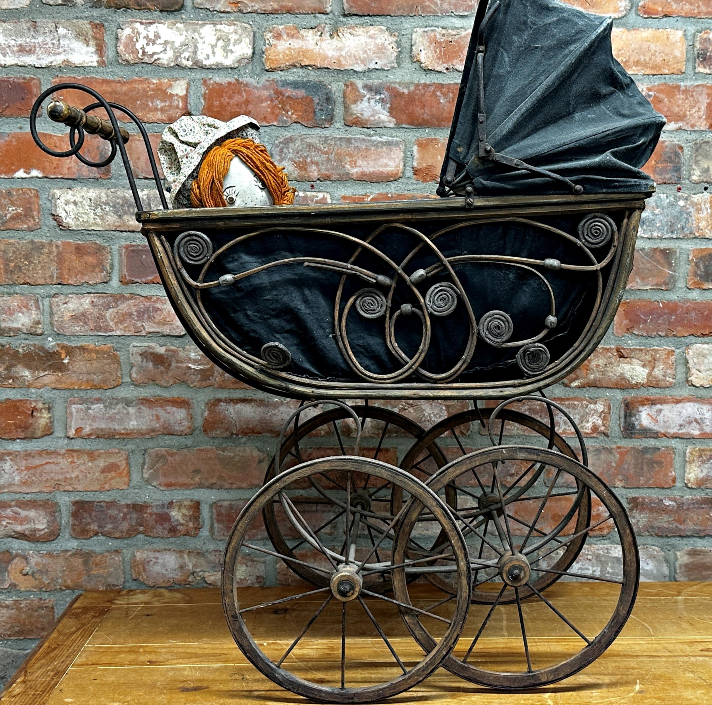 Antique wicker pram with pierced scrolling detail and fabric hood, 88cm high