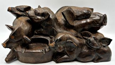 Eastern hardwood carving of overlapping pigs, 13cm high x 25cm long