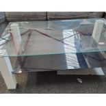 *EX DISPLAY* Modern tempered glass coffee table with smoled glass bottom shelf and 4 white posts.