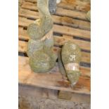 Two decorative garden statues, the tallest being 30cm