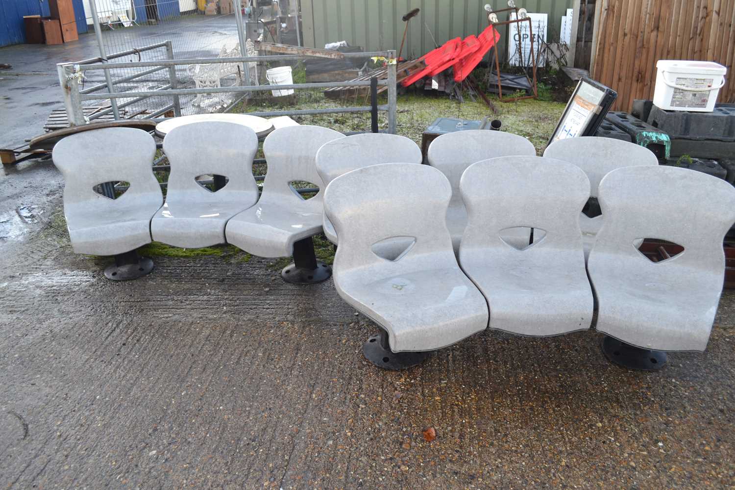 Three heavy duty commercial curved three seater benches together with a table