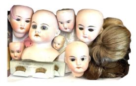 Small box containing various bisque doll heads, hair pieces, eyelashes etc. To include: - Armand