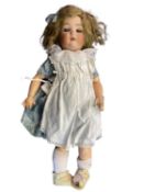 Simon & Halbig bisque head doll in blue dress and white pinafore. Blue eyes, blonde hair. Marked