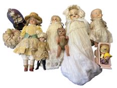A mixed lot of small unmarked dolls in various costumes.