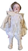 Simon & Halbig/K&R bisque head doll in white dress with cream cape. Flirty eyes. Marked to back of