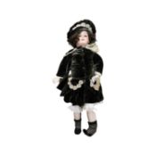 SFBJ bisque head doll in green velveteen dress and bonnet. Blue flirty eyes,brown hair. Marked to