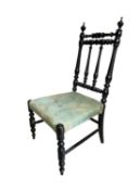 An ebonised childs' or dolls' chair with turned wooden legs/back and green upholstered seat.
