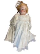 Simon & Halbig / K&R bisque head doll in white dress. Brown hair and eyes. Length approximatley