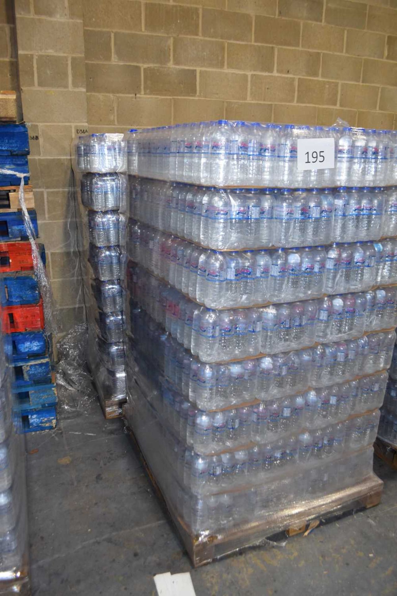 Two pallets of bottled water, each pallet containing 2300 500ml bottles with an expiry date of 26.