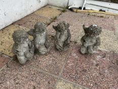 Four small composite statues formed as cherubs