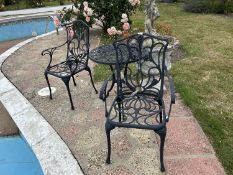 A decorative metal garden bistro set comprising a table and two chairs