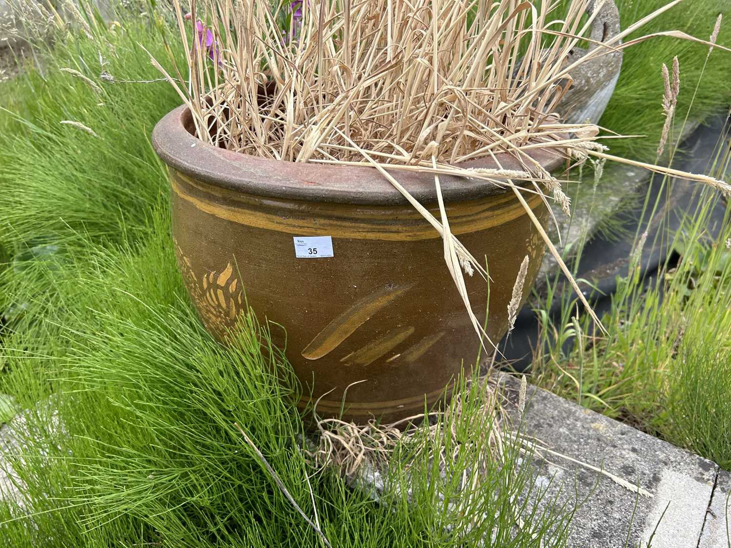 A pair of terracotta glazed plant pots, height approx 40cm, width approx 50cm