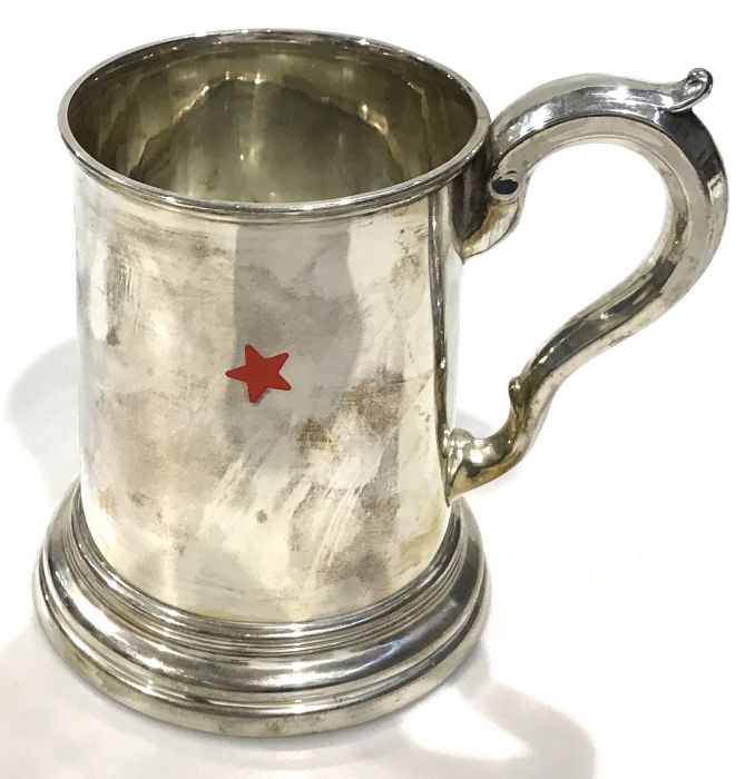 A silver plated tankard with glass bottom