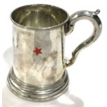 A silver plated tankard with glass bottom