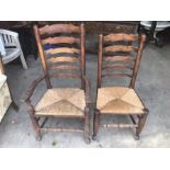 An Antique oak Lancashire style wavy ladderback armchair, rush seat, on turned supports and turned