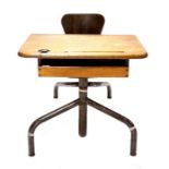 A French child's school desk, early 20th Century, oak top with ink pot hole, pen well and shelf