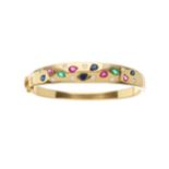 An 18ct gold sapphire, ruby, emerald and diamond hinged bangle bracelet