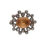 An early 19th century gold and silver, orange topaz and diamond brooch
