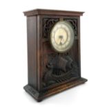 An Iona type Arts and Crafts carved oak clock