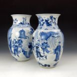 A pair of Chinese blue and white baluster vases, the openings with birds and insects amongst
