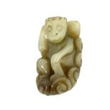 A Chinese pale and brown tinted jade carving, monkey with a large gourd, 5cm long