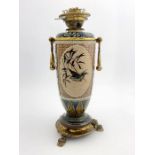 Florence Barlow for Doulton Lambeth, a stoneware oil lamp, 1883, footed ovoid form, decorated with