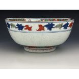 A Japanese imari bowl, 19th century, footed form, central floral composition in a vase, within