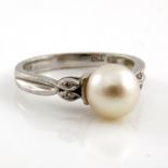 An 18kt white gold diamond set single pearl dress ring, 4.6g