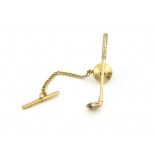 An American novelty 14kt gold and diamond lapel pin, modelled as a golf club and ball, Baumstein &