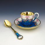 A French silver gilt enamel cabinet cup and saucer, early 20th Century, scroll handle, the