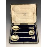 A set of three Victorian silver gilt serving spoons, entwined serpent finials, fitted case