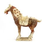 A Chinese pottery horse, believed to be Tang dynasty, (618-906) modelled standing tall wearing a