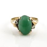 A 14kt gold and green gem set ring, with foliate moulded shoulders, 3.4g