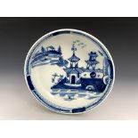 A Lowestoft blue and white saucer, circa 1760, painted with a Chinese watery landscape with