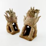 A near pair of Chinese pottery earth spirit guardians or tomb figures, possibly Tang dynasty, in the