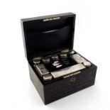 A late Victorian coromandel dressing case, inset presentation plaque dated 1876 to the cover, fitted