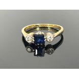 An 18ct gold and platinum sapphire and diamond three stone ring, total diamond weight 0.20ct