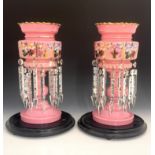 A pair of 19th century Bohemian pink glass lustres under domes, footed, scalloped rims, body with