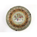 A large Cantonese circular charger, 19th Century, famille rose decorated with a central roundel of