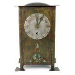 Jesson, Birkett and Co, an Arts and Crafts brass and abalone inlaid bracket clock, the silvered dial