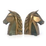 Reynolds Jones, a pair of Art Deco equestrian bronze horse head andirons, stamp marks, 28cm high (