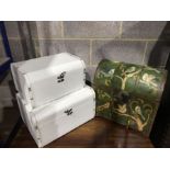 A set of two graduated faux white leather dome top caskets, together with a painted wooden metal