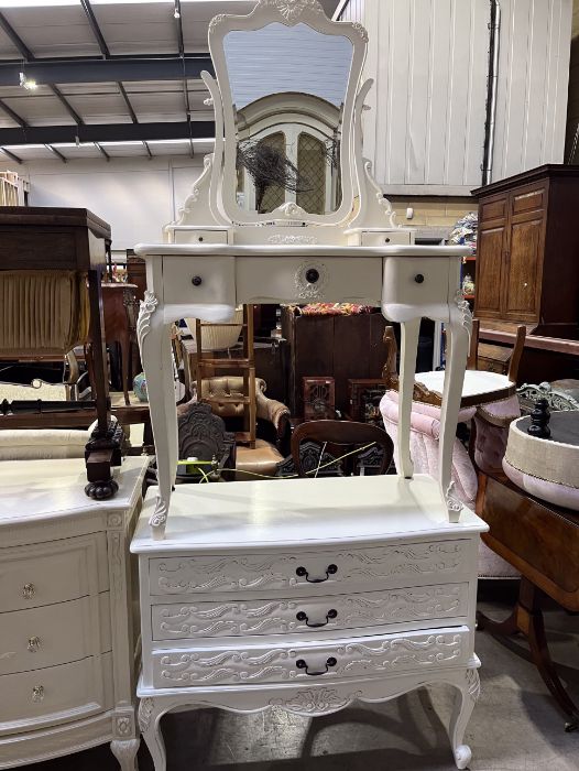 A collection of white painted bedroom furniture including bedside cabinets, tall boy, and dressing