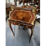 A Louis XV style bureau de dame, Bombe form with radiating veneered and banded panels, gilt metal